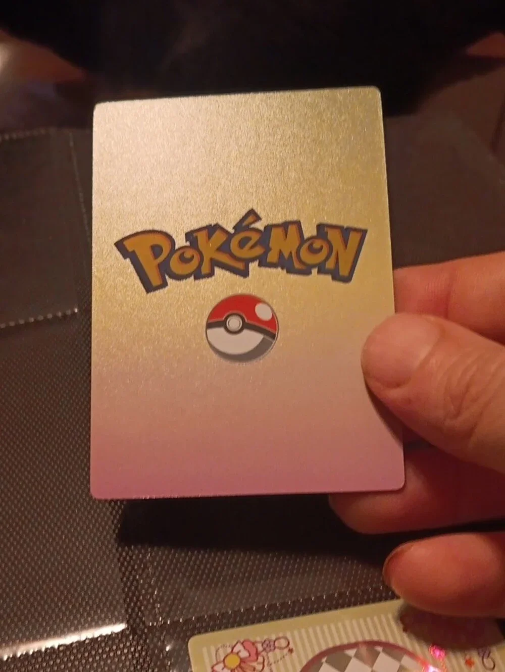 Pokemon Trading Card with Blue, Pink, Gold, White Artwork